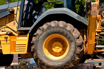 Fototapeta premium Giant Tractor Tire on Heavy Yellow Equipment