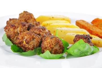 served meatballs on basil leaf