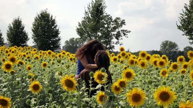 Happy young couple in sunflower field.