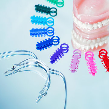 Multicolored ligature ties , prosthetic dentures and facebow