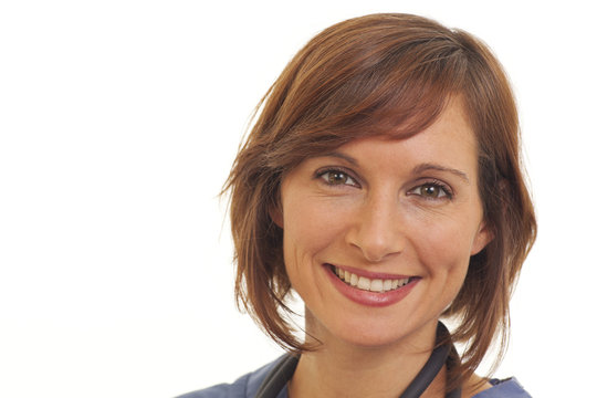 Portrait of smiling young woman doctor in scrubs