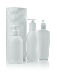 cosmetical bottles and white paper towel