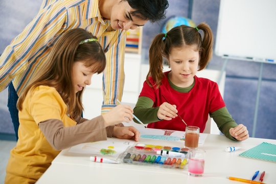 Children painting in art class at elementary school