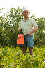 working man with garden spray