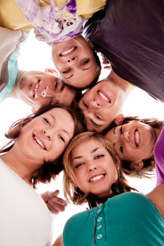 smiling teenagers in circle