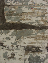 heavily damaged grunge wall with blathering paint and repair