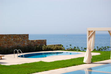 Swimming pool with jacuzzi at the beach of modern luxury villa,