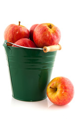 Green bucket with red apples