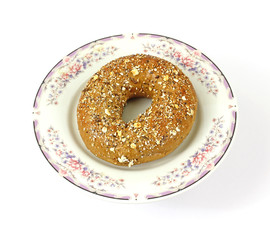 Whole wheat multi-grain bagel on vintage plate