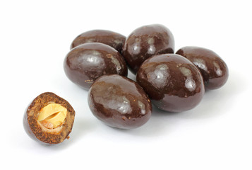 Milk chocolate covered almonds with one bitten in half