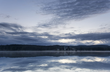 Lake view. Late summer with fog over the horizon.