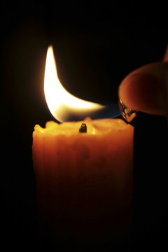 hand lighting candle