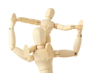 wooden figures of child sitting on neck of his parent