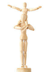 wooden figures of child sitting on neck of his parent