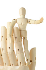 wooden figure of little man standing on big hand and pointing