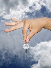 Fototapeta na wymiar Man Handing Over the House Keys , Clouds and Sky.