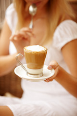 Attractive woman enjoying cup of coffee