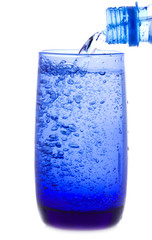 water is pouring into a glass from bottle