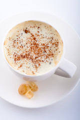 mug of coffee with whipped cream, cinnamon and caramel sugar