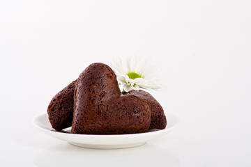 heart shaped cookie with flower on a plate