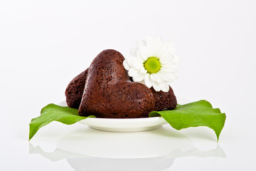 heart shaped cookie with flower and leafs on a plate