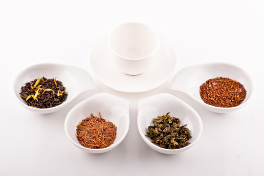 four kinds of tea in small white plates