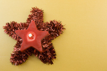 red star candle on tinsel star