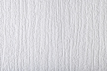 Surface of white wallpaper having the relief
