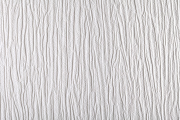 Surface of white wallpaper having the relief