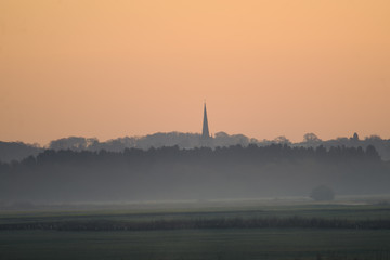 Fototapeta premium misty landscape with church in the distance