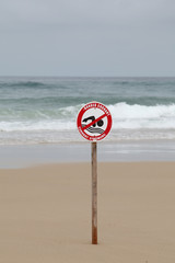 Agitated sea with no swimming sign
