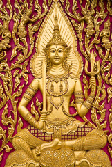 Fototapeta premium Buddha carved gold paint on church door