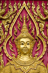 Fototapeta na wymiar Buddha carved gold paint on church door