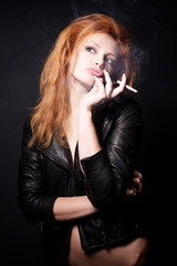 Portrait of beautiful redhead woman with a cigarette