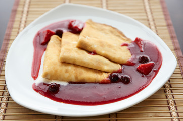 Plate of delicious pancakes with berry jam