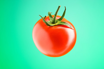 Fresh red tomato against the gradient background