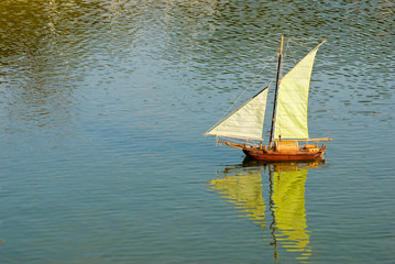 Handmade remote control sailboat on lake