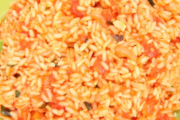 Food background: Risotto with tomatoes in close up