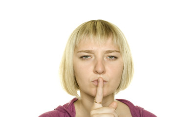 Fototapeta premium Young Woman Gesturing for Quiet or Shushing