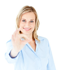 Confident young businesswoman showing OK sign