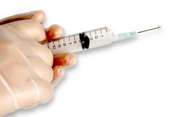 Hands with syringe over white