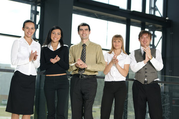 Fototapeta premium A group of five young business persons in a modern office