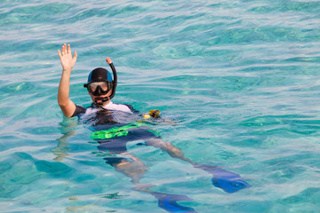 Man in flippers and mask in ocean, Maldives