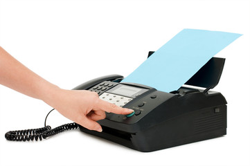The hand presses the fax button