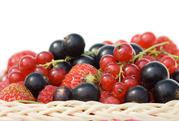 Ripe berries in a basket isolated on white background