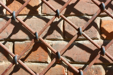 Closeup of an old brick wall covered with wirecloth