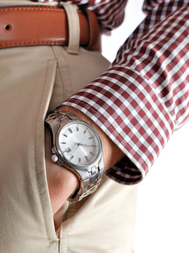 Watch on the men's hand in a pocket of pants