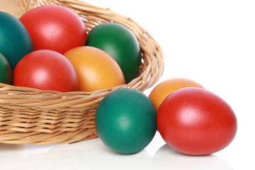 Fototapeta na wymiar Colour Easter eggs in a wattled basket
