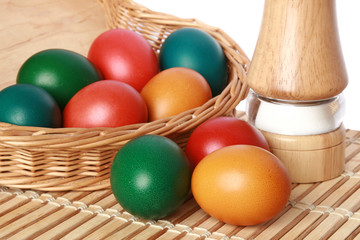 Obraz na płótnie Canvas Colour Easter eggs in a wattled basket