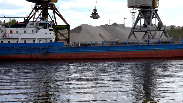 ship's crane unloads sand